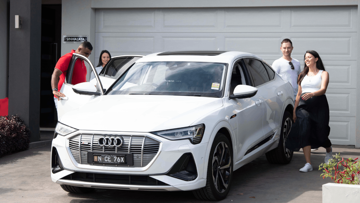family excited to drive their new car