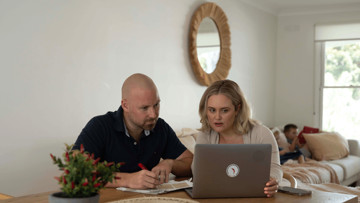 couple budgeting on a laptop